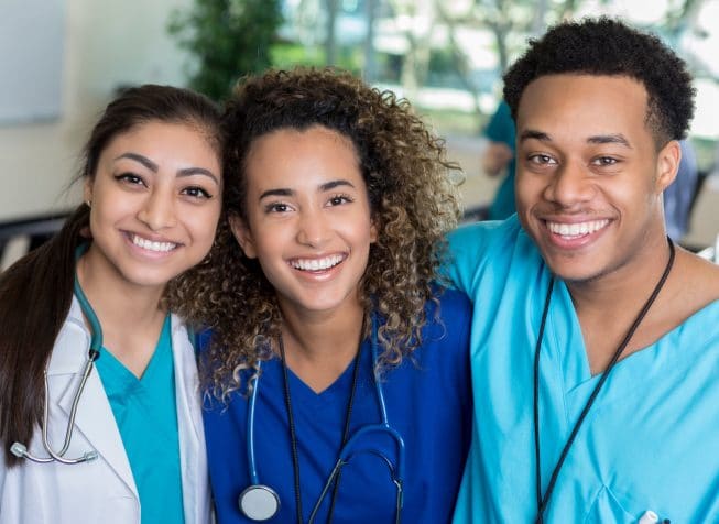 three young nurses smiling